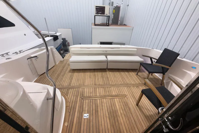 Slide: The Image of Luxurious 2001 Sea Ray 560 Sedan Bridge yacht interior with teak flooring and elegant seating. - 15