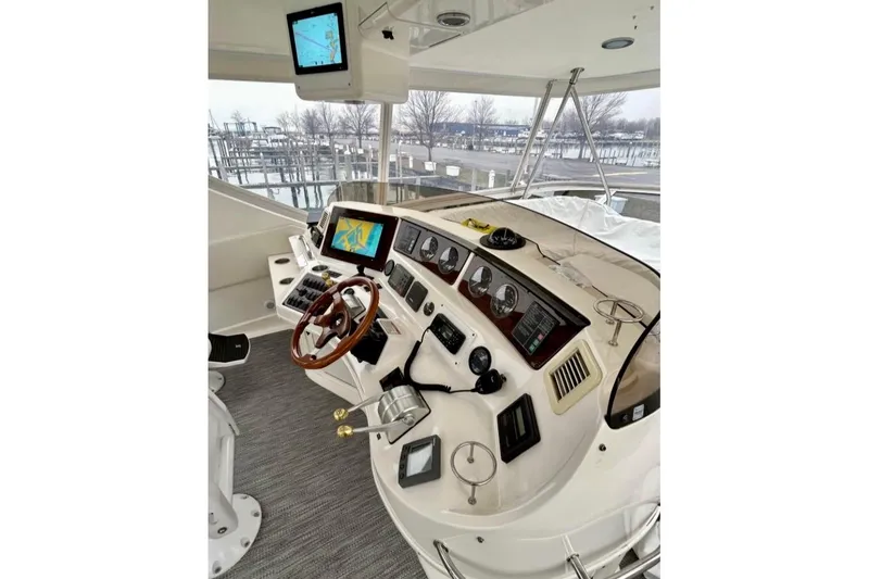 Slide: The Image of Helm of 2001 Sea Ray 560 Sedan Bridge with navigation screens and controls. - 16