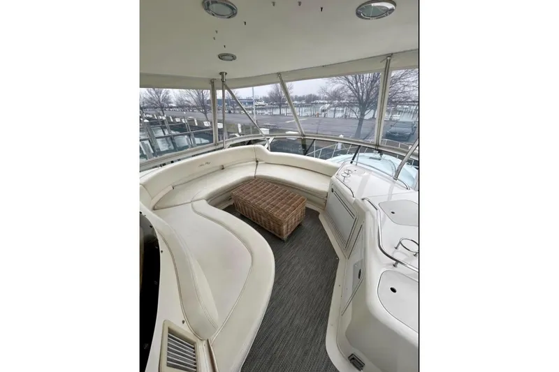 Slide: The Image of Luxurious 2001 Sea Ray 560 Sedan Bridge yacht interior with spacious seating and wicker table. - 20