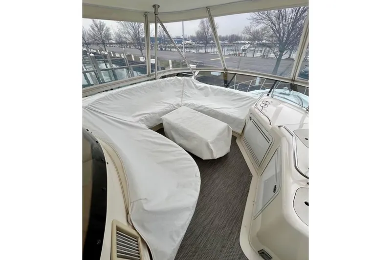 Slide: The Image of 2001 Sea Ray 560 Sedan Bridge yacht interior with covered seating area. - 21