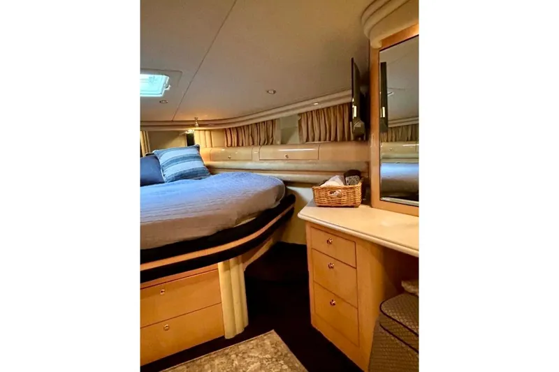 Slide: The Image of Luxurious cabin interior of 2001 Sea Ray 560 Sedan Bridge yacht with cozy bed and storage. - 35