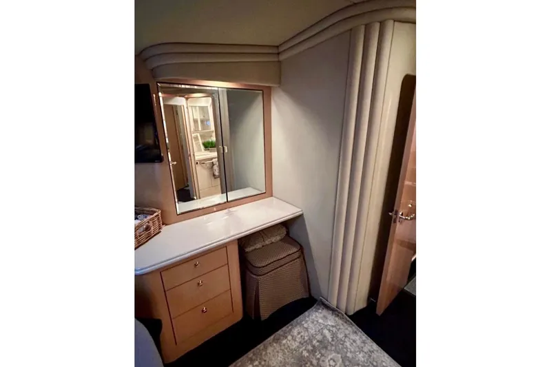 Slide: The Image of Interior of 2001 Sea Ray 560 Sedan Bridge with vanity, mirror, and storage drawers. - 36