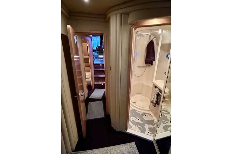 Slide: The Image of Interior of 2001 Sea Ray 560 Sedan Bridge yacht, featuring a modern bathroom and hallway. - 37