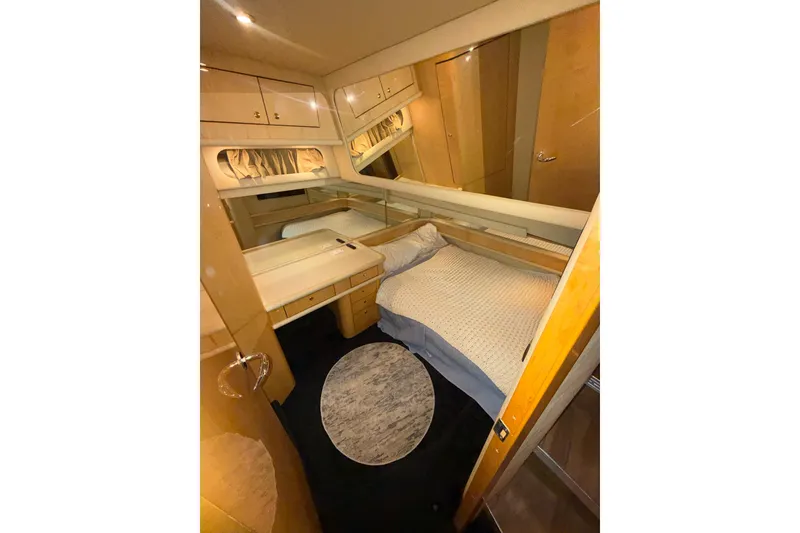 Slide: The Image of Luxurious cabin interior of 2001 Sea Ray 560 Sedan Bridge yacht with cozy bed and wood finish. - 41