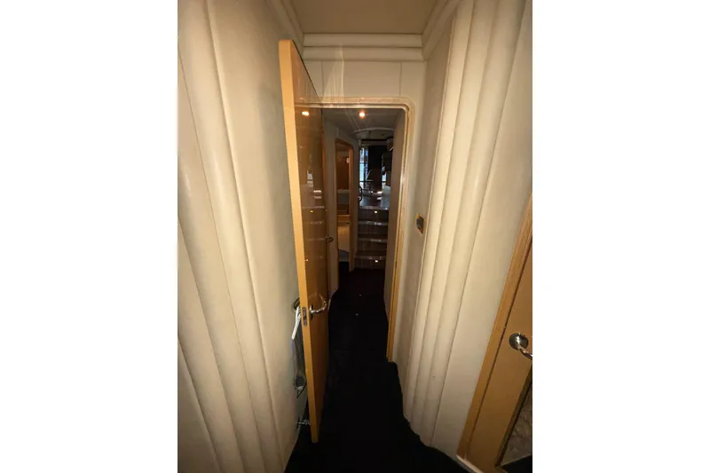 Slide: The Image of Interior hallway of 2001 Sea Ray 560 Sedan Bridge yacht, featuring open door and elegant design. - 46
