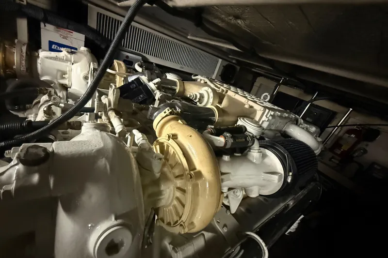 Slide: The Image of Engine room of a 2001 Sea Ray 560 Sedan Bridge yacht, showcasing mechanical components. - 54