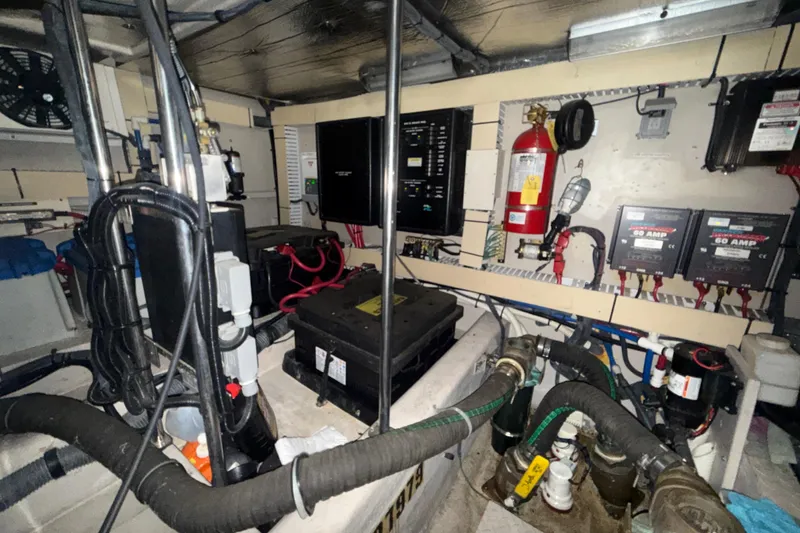 Slide: The Image of Engine room of a 2001 Sea Ray 560 Sedan Bridge with electrical systems and fire extinguisher. - 59