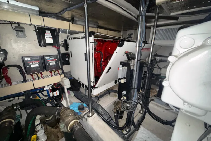 Slide: The Image of Engine room of a 2001 Sea Ray 560 Sedan Bridge with visible machinery and wiring. - 61