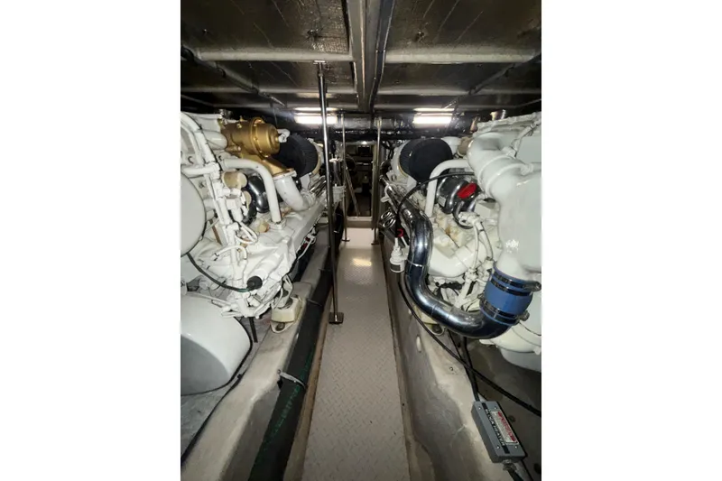 Slide: The Image of Engine room of a 2001 Sea Ray 560 Sedan Bridge yacht, showcasing dual engines. - 65