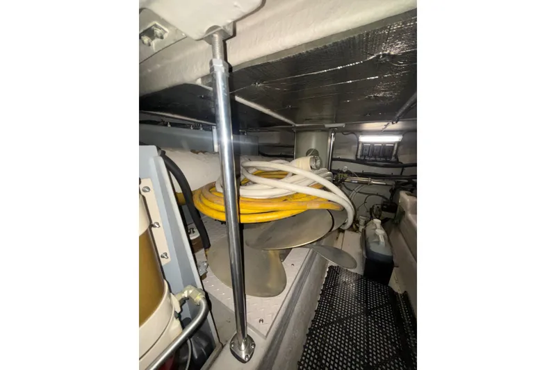 Slide: The Image of Engine room of 2001 Sea Ray 560 Sedan Bridge with propeller and cables. - 66