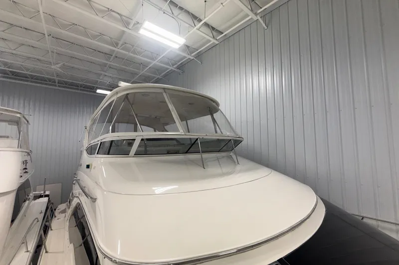 Slide: The Image of 2001 Sea Ray 560 Sedan Bridge yacht in indoor storage facility. - 8