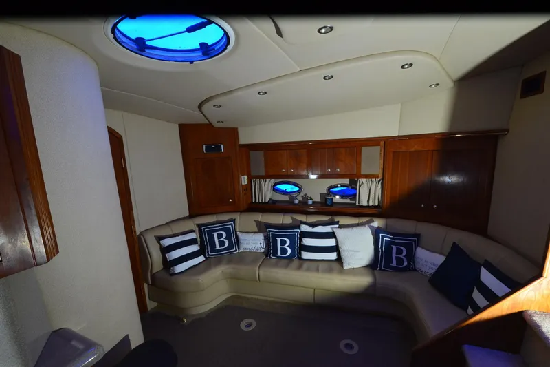 Slide: The Image of Interior of 2003 Cruisers Yachts 4370 Express with plush seating and nautical decor. - 12
