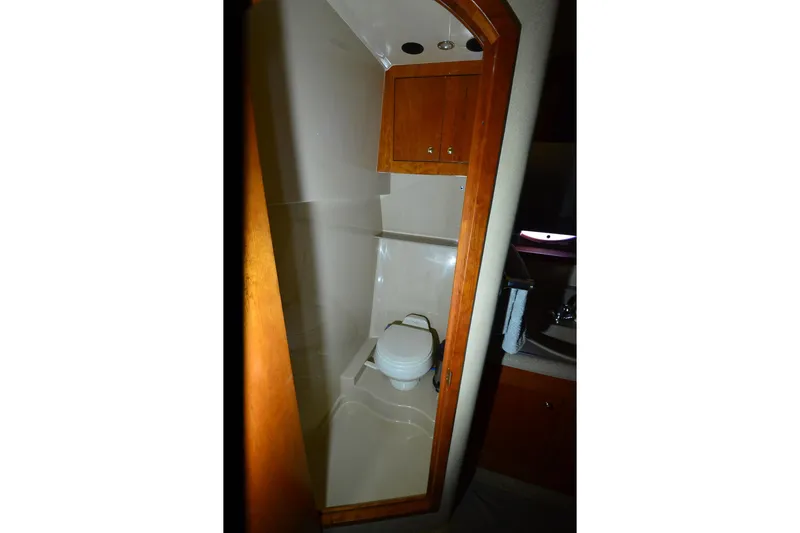 Slide: The Image of Bathroom interior of 2003 Cruisers Yachts 4370 Express with wooden cabinetry. - 15