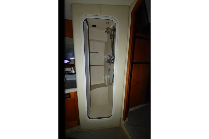Slide: The Image of Shower area inside 2003 Cruisers Yachts 4370 Express, featuring modern fixtures and compact design. - 17