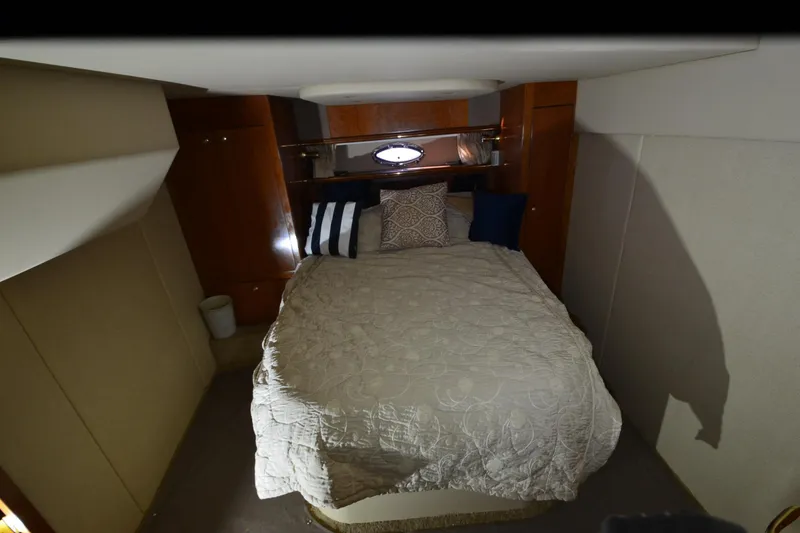 Slide: The Image of Interior cabin of 2003 Cruisers Yachts 4370 Express with cozy bed and pillows. - 18