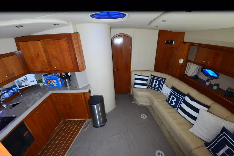 Slide: The Image of Interior of 2003 Cruisers Yachts 4370 Express with kitchen and cozy seating area. - 19