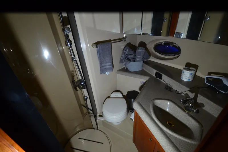 Slide: The Image of Bathroom interior of 2003 Cruisers Yachts 4370 Express with shower, sink, and toilet. - 21