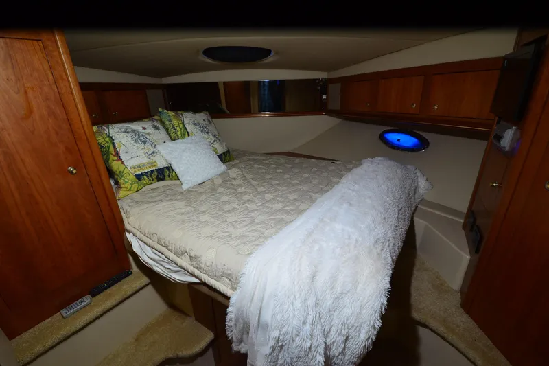 Slide: The Image of Luxurious cabin interior of 2003 Cruisers Yachts 4370 Express with cozy bedding. - 22