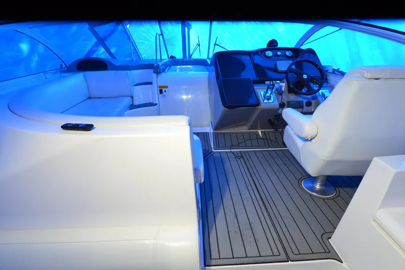 Slide: The Image of 2003 Cruisers Yachts 4370 Express interior with white seating and modern helm. - 26
