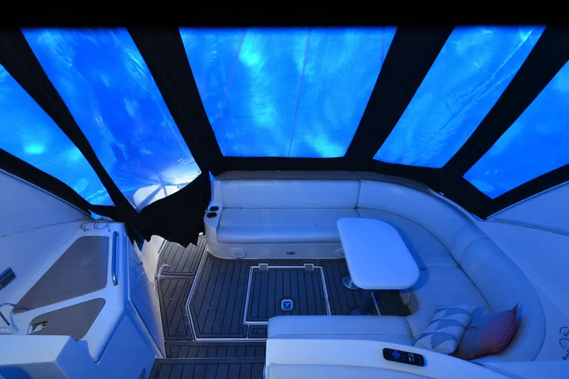 Slide: The Image of 2003 Cruisers Yachts 4370 Express interior with blue canopy, seating, and table. - 31