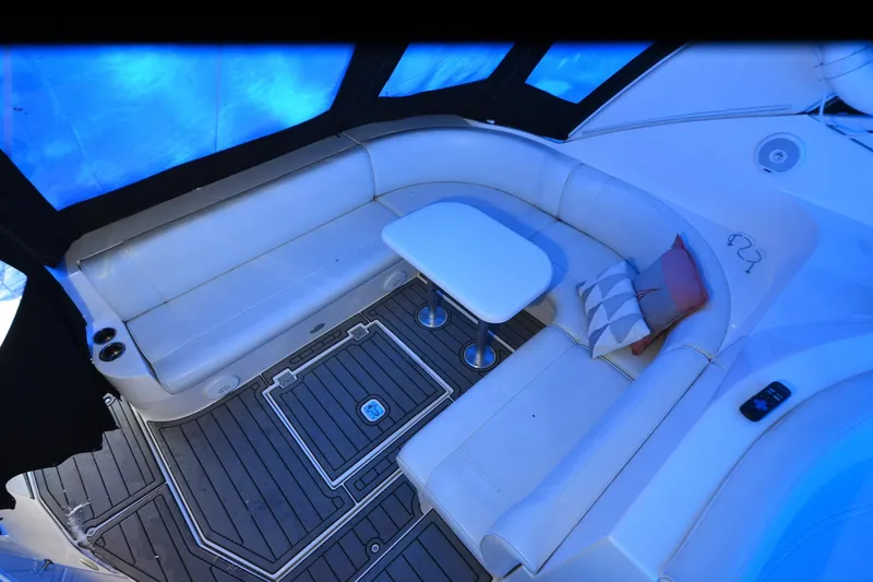 Slide: The Image of Luxurious seating area on 2003 Cruisers Yachts 4370 Express with cushions and table. - 32