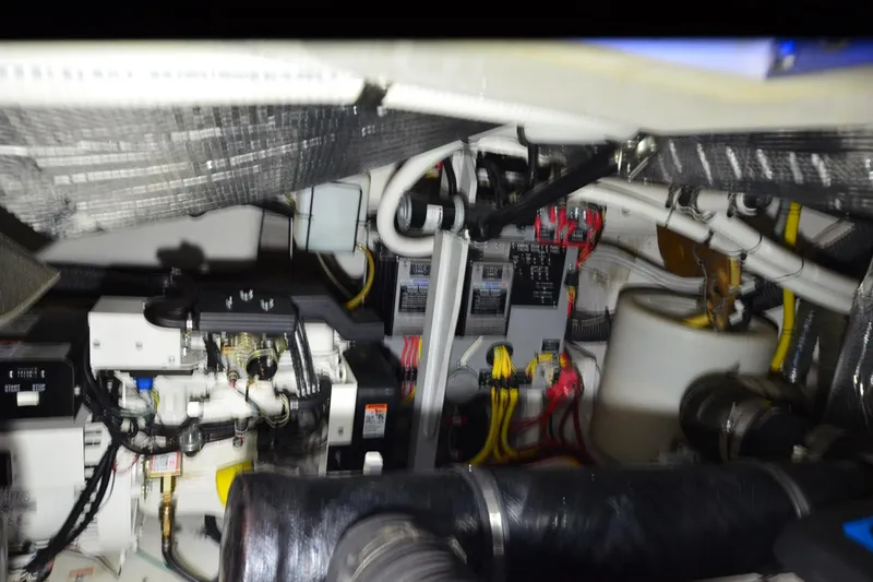 Slide: The Image of Engine room of 2003 Cruisers Yachts 4370 Express, showcasing mechanical components and wiring. - 35