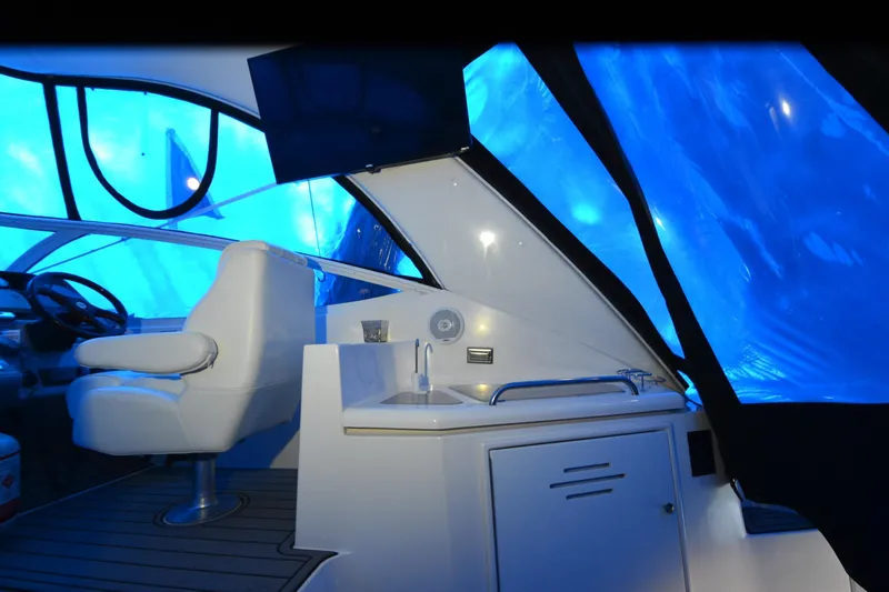 Slide: The Image of Interior of 2003 Cruisers Yachts 4370 Express with blue-tinted windows and helm station. - 37