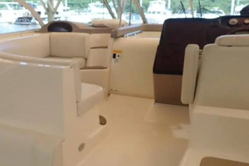 Slide: The Image of 2003 Cruisers Yachts 4370 Express interior with beige seating and helm. - 9