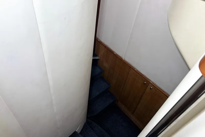 Slide: The Image of Interior staircase of 2003 Azimut 55 yacht with wooden paneling and carpeted steps. - 10