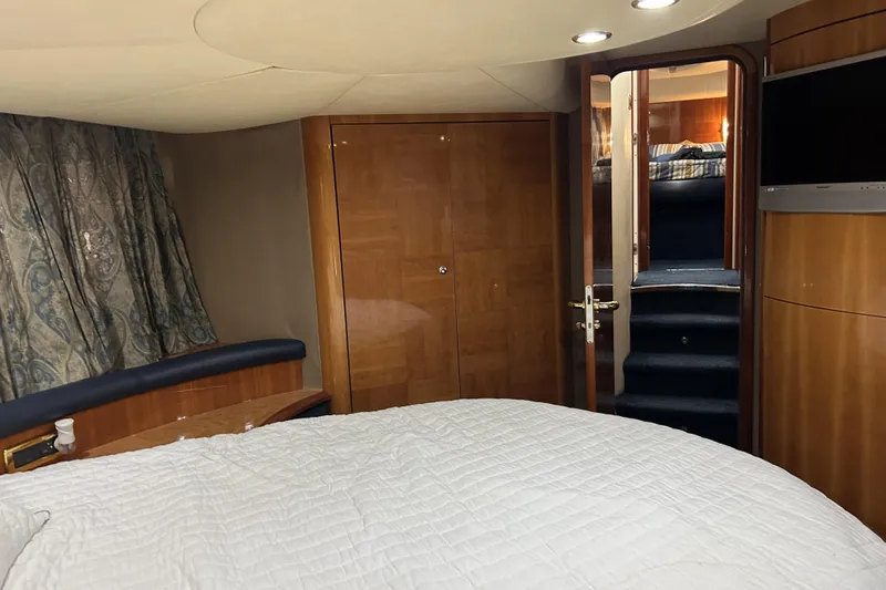 Slide: The Image of Luxurious 2003 Azimut 55 yacht bedroom with elegant wood finishes and cozy bedding. - 11
