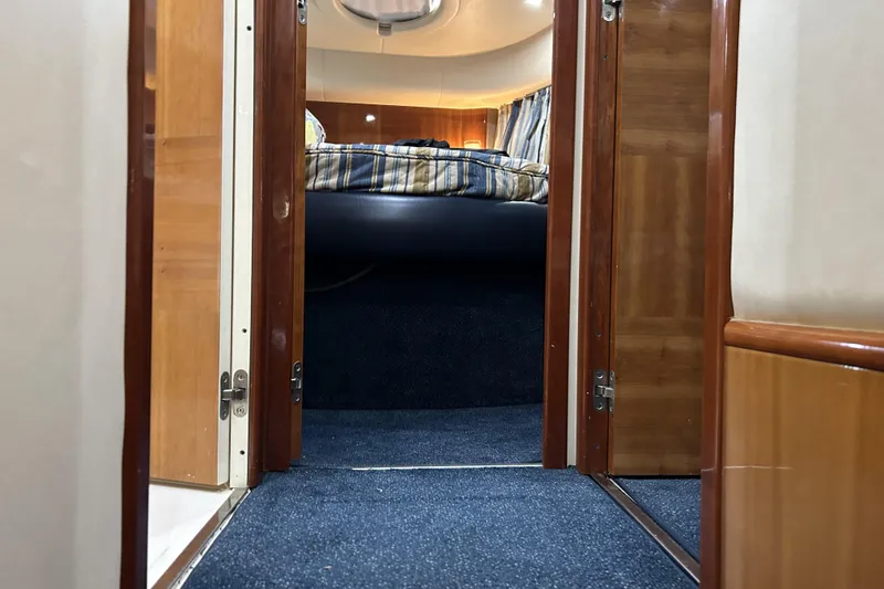 Slide: The Image of Interior of 2003 Azimut 55 yacht, featuring a cozy cabin with wooden finishes. - 12