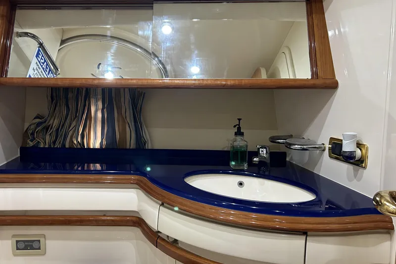 Slide: The Image of Luxurious bathroom interior of a 2003 Azimut 55 yacht with elegant wood accents. - 14