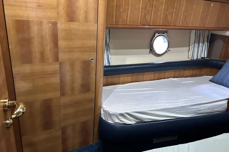 Slide: The Image of 2003 Azimut 55 yacht cabin with wooden interior and porthole window. - 18