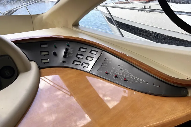 Slide: The Image of Control panel of a 2003 Azimut 55 yacht, featuring navigation and system controls. - 5