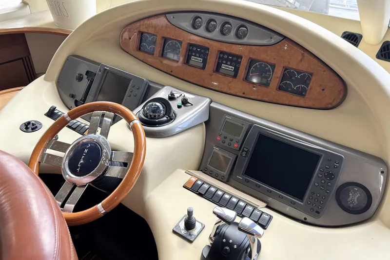 Slide: The Image of 2003 Azimut 55 yacht helm with wooden steering wheel and navigation instruments. - 6