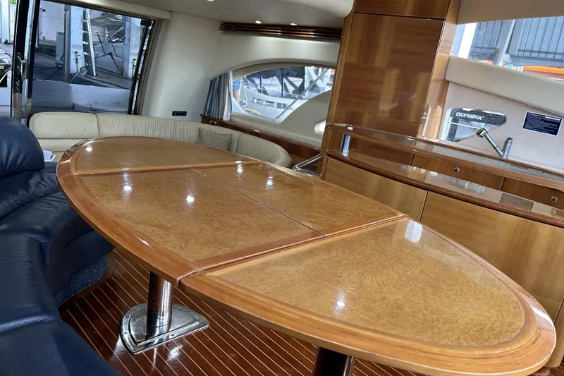 Slide: The Image of Luxurious interior of 2003 Azimut 55 yacht with elegant wood finishes and seating area. - 8
