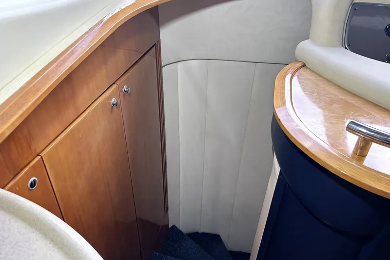 Slide: The Image of Interior of 2003 Azimut 55 yacht, featuring wooden cabinetry and elegant design. - 9