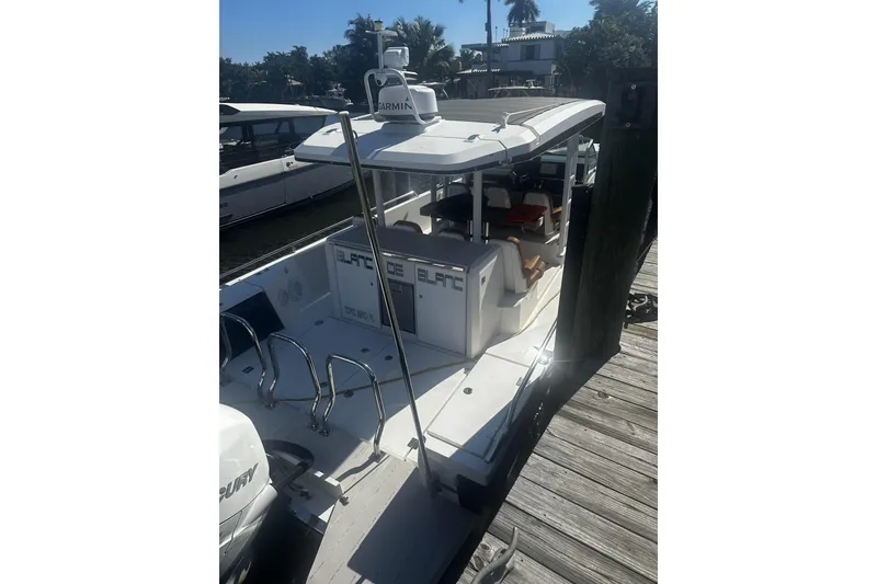 Slide: The Image of 2018 Axopar 37 Sun-Top boat helm with steering wheel and navigation controls. - 4