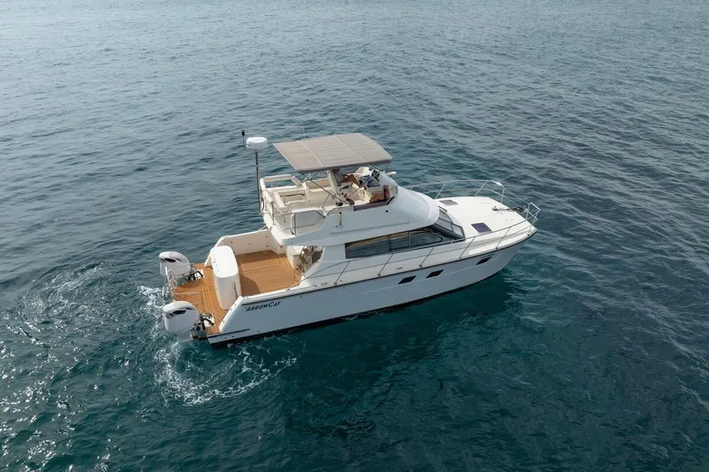 Slide: The Image of 2023 ArrowCat 420 Flybridge cruising on open water, showcasing sleek design and spacious deck. - 1
