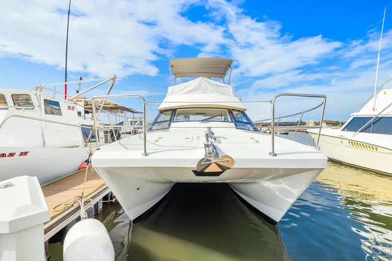 Slide: The Image of 2023 ArrowCat 420 Flybridge yacht docked at marina under blue sky. - 13