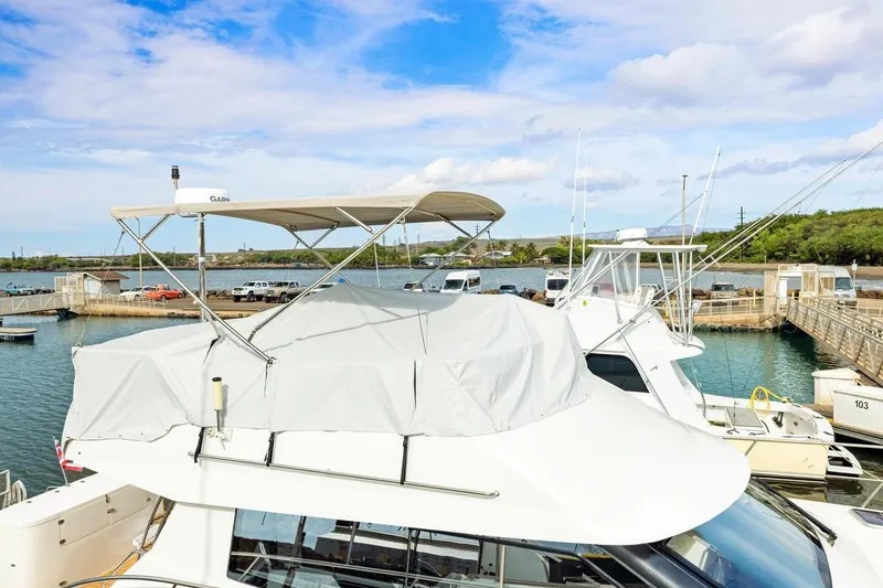Slide: The Image of 2023 ArrowCat 420 Flybridge yacht docked at marina under blue sky. - 15