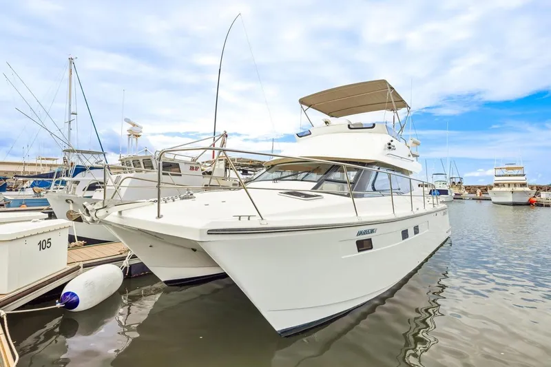Slide: The Image of 2023 ArrowCat 420 Flybridge yacht docked in marina under blue sky. - 16