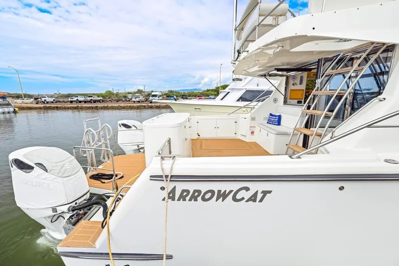 Slide: The Image of 2023 ArrowCat 420 Flybridge yacht docked, showcasing sleek design and powerful engines. - 19