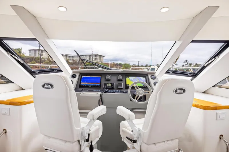 Slide: The Image of Interior view of 2023 ArrowCat 420 Flybridge helm with dual seats and navigation equipment. - 24