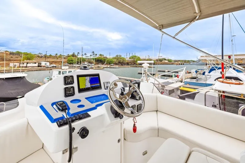 Slide: The Image of Flybridge of 2023 ArrowCat 420 with modern navigation equipment, docked in a marina. - 30