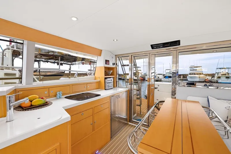 Slide: The Image of Luxurious 2023 ArrowCat 420 Flybridge yacht interior with modern kitchen and marina view. - 31