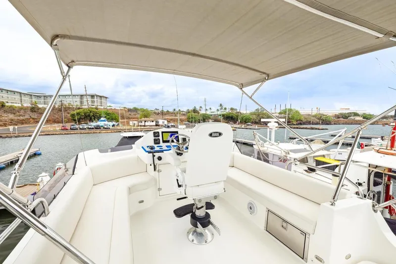 Slide: The Image of 2023 ArrowCat 420 Flybridge yacht helm with seating, docked in a marina. - 35