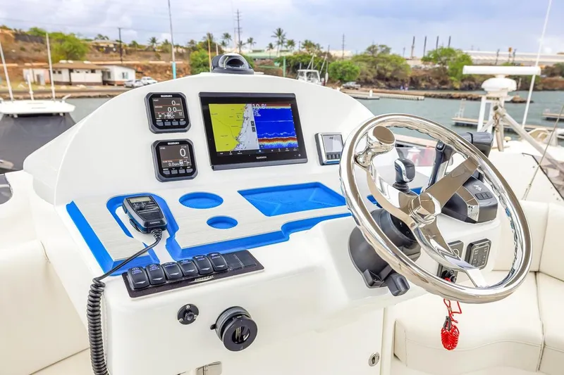Slide: The Image of 2023 ArrowCat 420 Flybridge helm with navigation controls and steering wheel. - 38