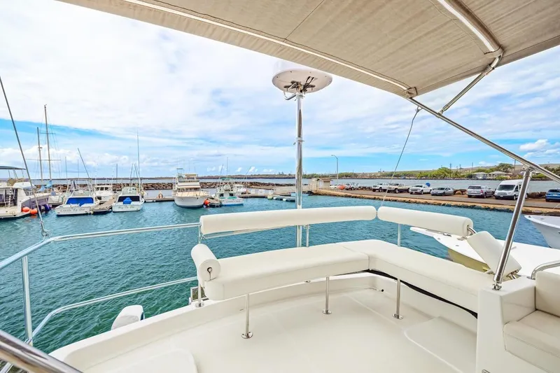 Slide: The Image of 2023 ArrowCat 420 Flybridge yacht with marina view, featuring spacious seating and canopy. - 39