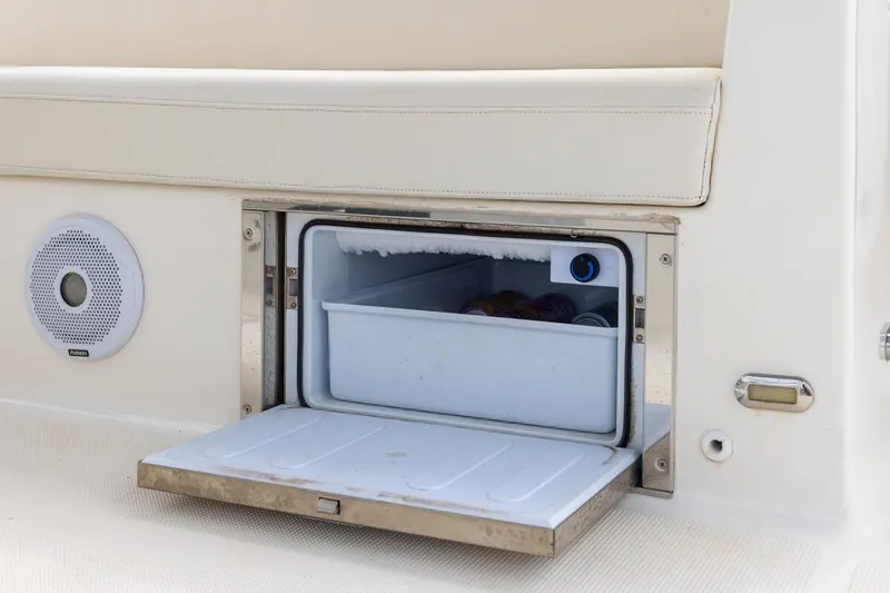 Slide: The Image of Open mini fridge on 2023 ArrowCat 420 Flybridge boat, showcasing interior storage. - 40